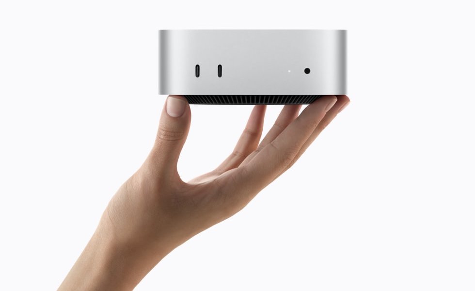 Nuevo Mac mini de Apple con puertos frontales sostenido sobre una mano